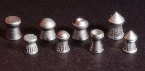 From left to right, wadcutter, domed, hollow point and pointed pellets. Top row .22 caliber (5.5 mm), bottom .177 (4.5 mm) caliber.